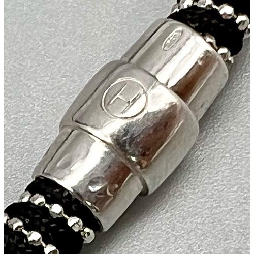 990 - STERLING SILVER WITH BLACK MATERIAL MAGNETIC CLASP BRACELET. 17CM LENGTH