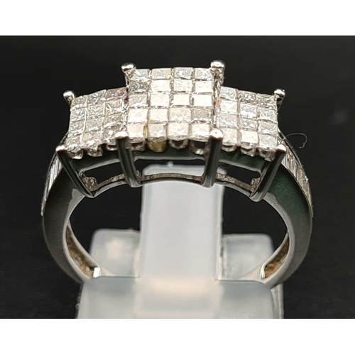 236 - An 18K White Gold Princess-Cut Diamond Ring. Twenty brilliant white central diamonds with twelve dia... 