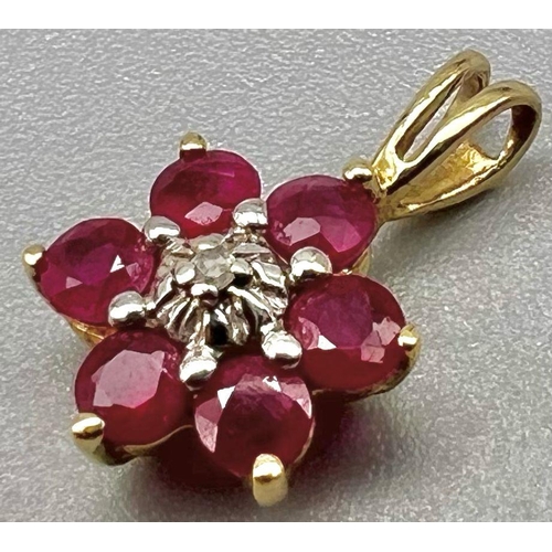 1020 - A 9 K yellow gold pendant with a central ruby surrounded by diamonds. weight: 05 g.