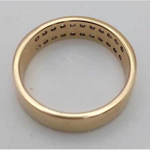 123 - A 9 K yellow gold ring with two diamond (0.50 carats) bands on top. Ring size: R, weight: 5 g.