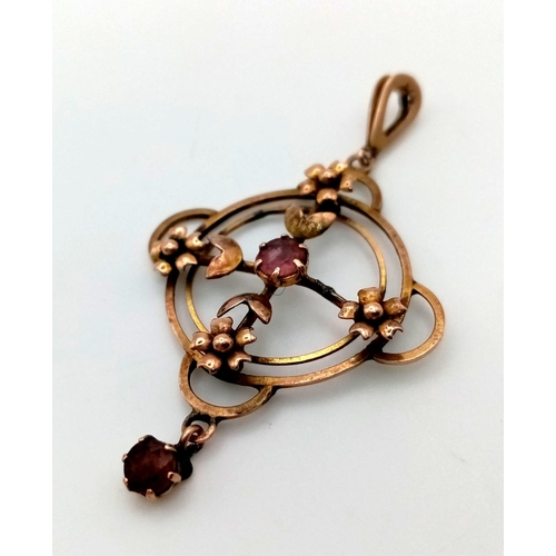 1267 - A Victorian 9K Gold Red and Pink Gemstone Circular Floral Pendant. 30mm. 2.51g total weight.