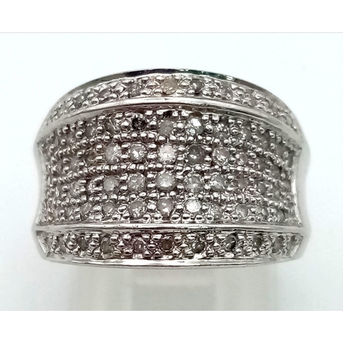 384 - A 9K White Gold Diamond Wide Band Cluster Ring. Size J 1/2. 5.68g total weight.