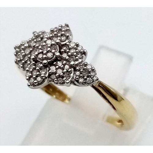 640 - A 9 K yellow gold ring with a cluster of diamonds set on white gold. Total 0.40 carats of diamonds. ... 