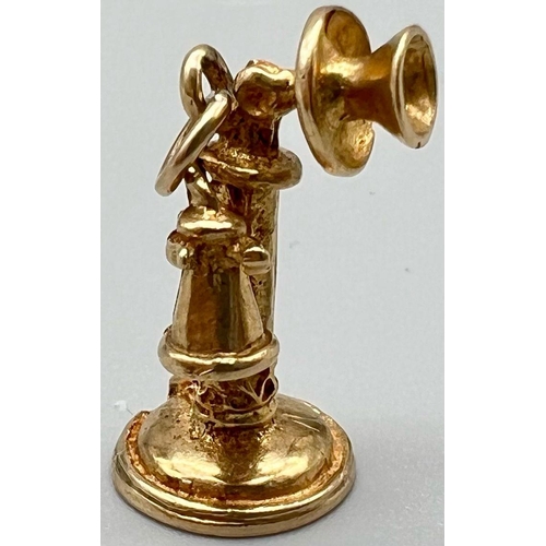 698 - A 9 K yellow gold charm in the shape of an old telephone.  weight: 3.6 g.