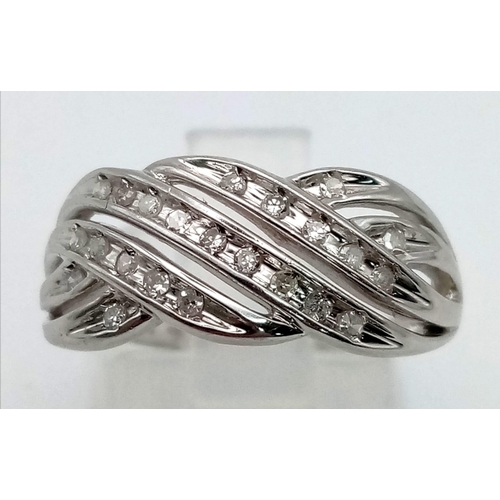 711 - A 9 K white gold ring with three twisted diamond bands. Ring size: L, weight: 2.9 g.