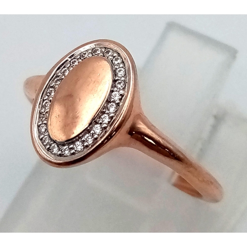 992 - A 9 K rose gold signet ring with a halo of white sapphires. Ring size: G, weight: 1.1 g.