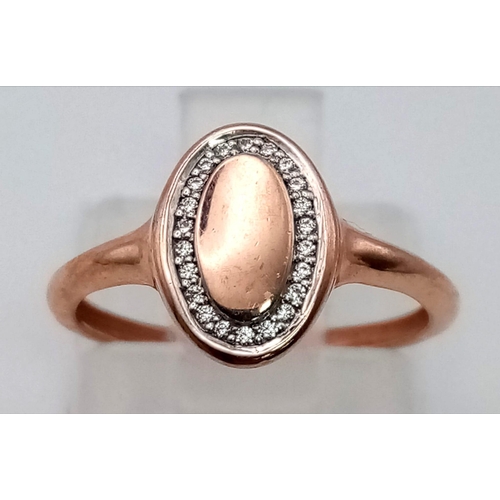 992 - A 9 K rose gold signet ring with a halo of white sapphires. Ring size: G, weight: 1.1 g.