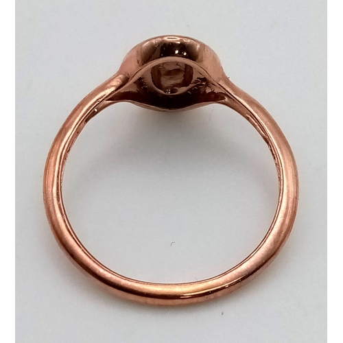 992 - A 9 K rose gold signet ring with a halo of white sapphires. Ring size: G, weight: 1.1 g.