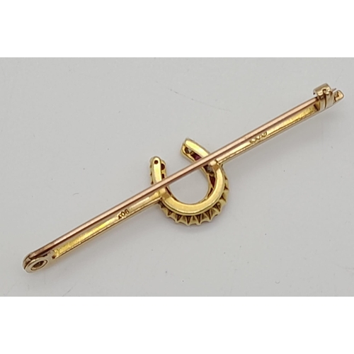 122 - An Antique Victorian 9K Yellow Gold, Ruby and Diamond Lucky Horse-shoe Bar Brooch. Six quality diamo... 