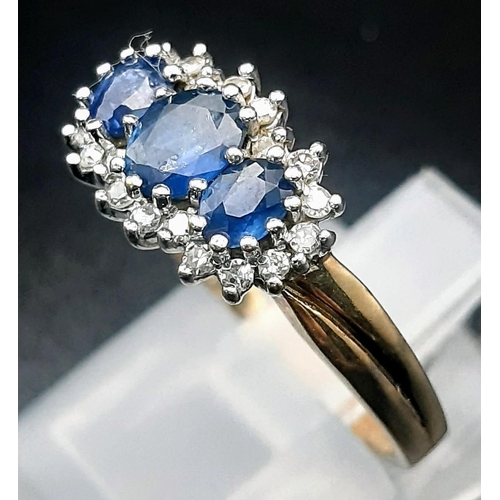 240 - A 9 K yellow gold ring with a trilogy of blue sapphires surrounded by diamonds (0.15 carats). Size: ... 