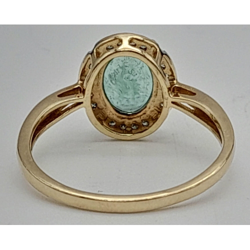 661 - A 14 K yellow gold ring with a Colombian, oval cut, emerald, surrounded by a halo of diamonds. Ring ... 