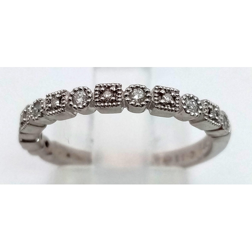 725 - A 9 K white gold ring with a diamond (0.11 carats) band around two thirds of the ring. Size: N, weig... 