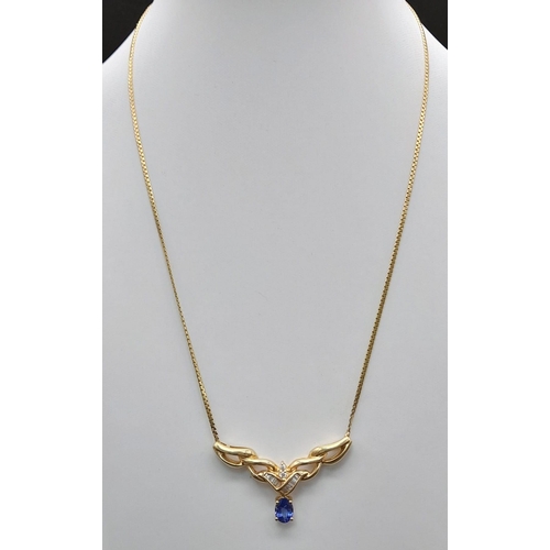 86 - A 14 K yellow gold chain necklace with a beautiful blue sapphire and baguette and brilliant cut diam... 