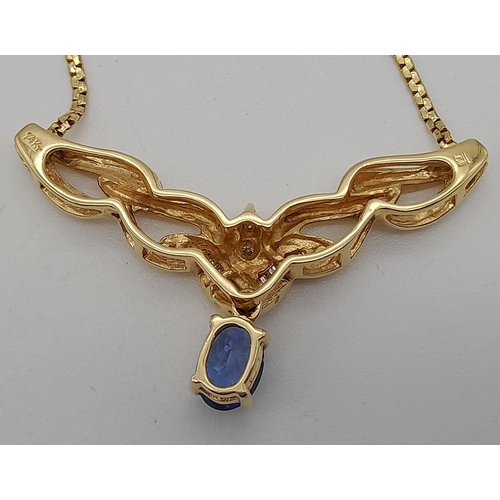 86 - A 14 K yellow gold chain necklace with a beautiful blue sapphire and baguette and brilliant cut diam... 