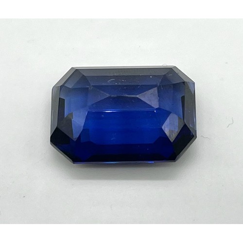 433 - A 44ct Emerald Cut Sapphire Blue Coloured Gemstone. 23 x 20mm. No certificate so as found.