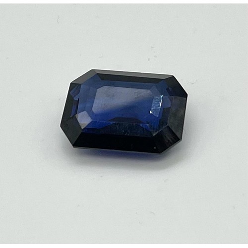 433 - A 44ct Emerald Cut Sapphire Blue Coloured Gemstone. 23 x 20mm. No certificate so as found.