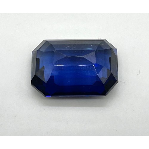 433 - A 44ct Emerald Cut Sapphire Blue Coloured Gemstone. 23 x 20mm. No certificate so as found.