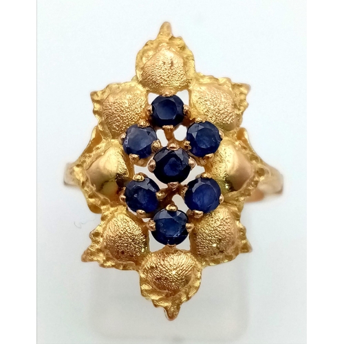 289 - A 1950s High Karat Yellow Gold (20 or more) Sapphire Ring. Eight quality clean sapphires surrounded ... 