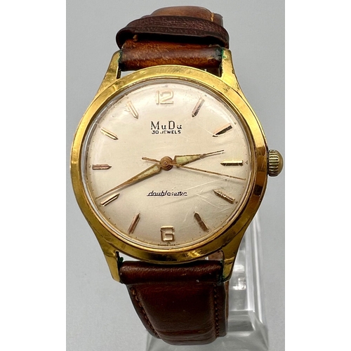 391 - A Vintage Mudu Doublematic Gents Watch. Brown leather strap. Gilded case - 35mm. In working order.