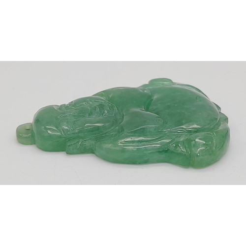 713 - A Green Jade Buddha Pendant. 5 x 4cm.