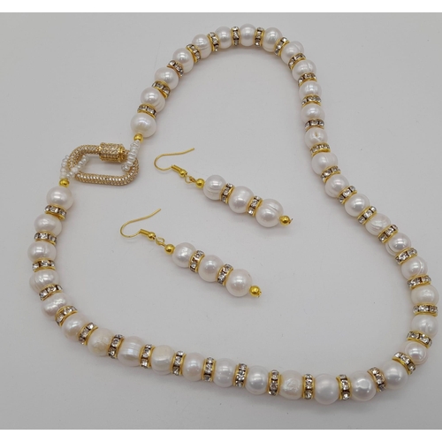 245 - A glamorous natural pearls necklace and earrings set with cubic zirconia and a fancy, unusual clasp.... 