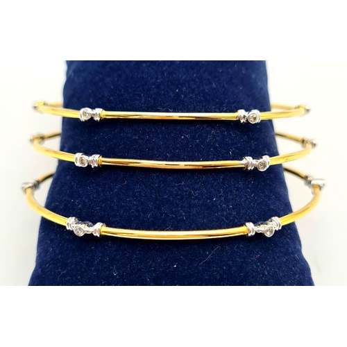 873 - A SET OF 3 DIAMOND SLAVE BANGLES IN 21K GOLD.  17.6gms