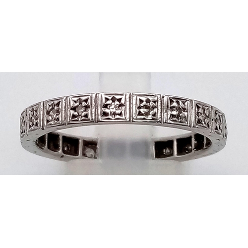 866 - AN 18K WHITE GOLD DIAMOND ETERNITY RING.  4.3gms  size V