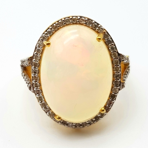 195 - An Australian Fire Opal Gemstone Ring with Halo of Diamonds set in 925 gilded silver. Total gem weig... 