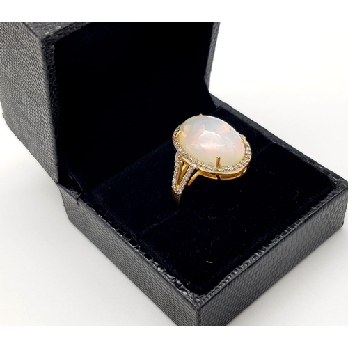 195 - An Australian Fire Opal Gemstone Ring with Halo of Diamonds set in 925 gilded silver. Total gem weig... 