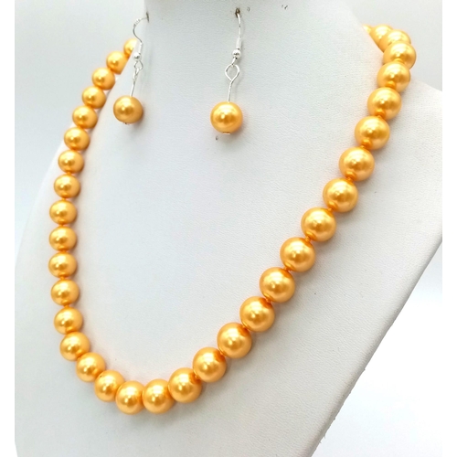 399 - A South Sea Pearl Shell Golden Necklace, Bracelet and Earring Set. 42cm. 16cm. 3cm drop.