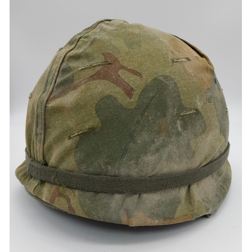 253 - A Vietnam War Era US M1 Helmet and Liner. With reversible camouflage cover.