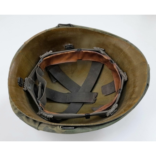 253 - A Vietnam War Era US M1 Helmet and Liner. With reversible camouflage cover.