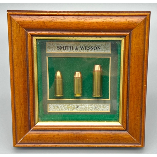 381 - A Smith and Wesson Bullet Display Case. .38, .40 and .44 calibre. In frame - 15 x 15cm. All rounds a... 