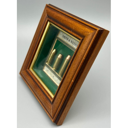 381 - A Smith and Wesson Bullet Display Case. .38, .40 and .44 calibre. In frame - 15 x 15cm. All rounds a... 