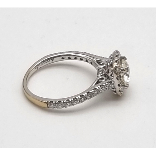 10 - An 18K White Gold Diamond Ring. A brilliant round-cut central diamond of 0.8ct surrounded by a halo ... 