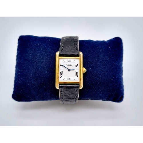 181 - A Must De Cartier Silver Gilded Ladies Quartz Tank Watch. Original leather strap with gilded clasp. ... 