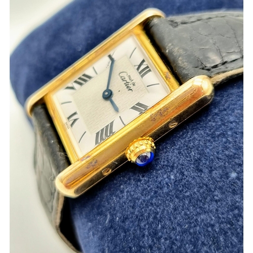 181 - A Must De Cartier Silver Gilded Ladies Quartz Tank Watch. Original leather strap with gilded clasp. ... 