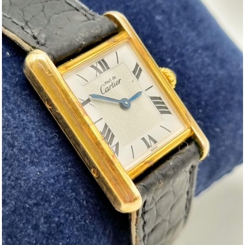 181 - A Must De Cartier Silver Gilded Ladies Quartz Tank Watch. Original leather strap with gilded clasp. ... 