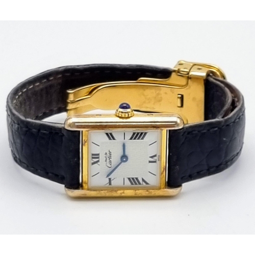 181 - A Must De Cartier Silver Gilded Ladies Quartz Tank Watch. Original leather strap with gilded clasp. ... 