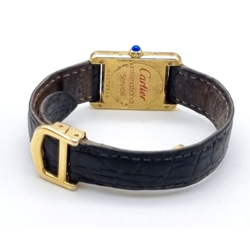 181 - A Must De Cartier Silver Gilded Ladies Quartz Tank Watch. Original leather strap with gilded clasp. ... 