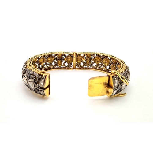 271 - An Antique High Karat Gold, Platinum and Diamond Bangle. Rich gold covered with a platinum foundatio... 