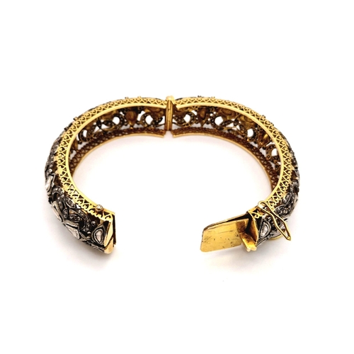 271 - An Antique High Karat Gold, Platinum and Diamond Bangle. Rich gold covered with a platinum foundatio... 