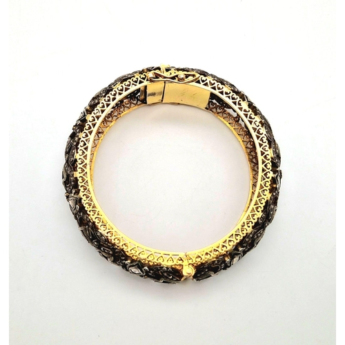 271 - An Antique High Karat Gold, Platinum and Diamond Bangle. Rich gold covered with a platinum foundatio... 