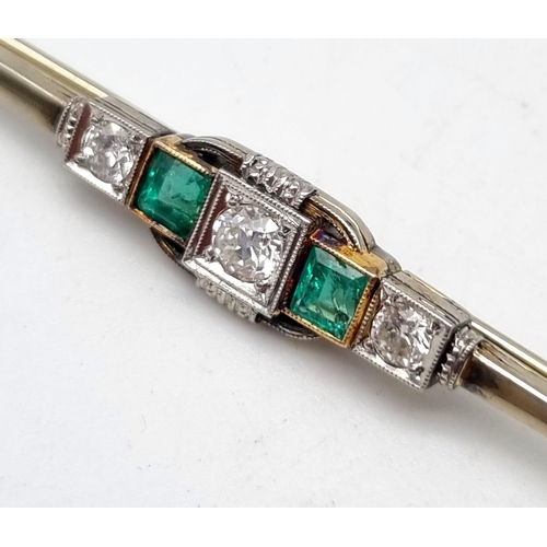 38 - A 14K White Gold Emerald and Diamond Bar Brooch. Central round cut diamond flanked by an emerald and... 