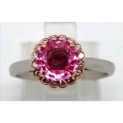 135 - An 18k rose gold and platinum ring with a natural unheated 1.25ct pink sapphire with a halo of round... 