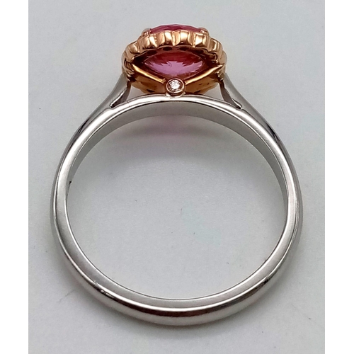 135 - An 18k rose gold and platinum ring with a natural unheated 1.25ct pink sapphire with a halo of round... 