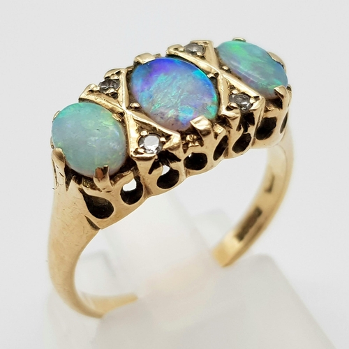 1494 - A Vintage 9K Yellow Gold Opal and Diamond Ring. Three exquisite oval cut opals take centre stage. Si... 