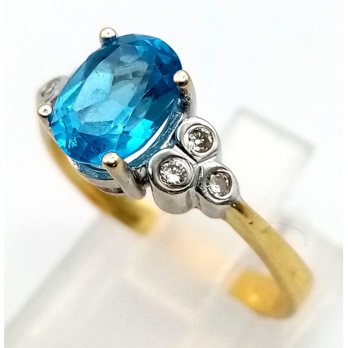 311 - An 18 K yellow gold ring with a beautiful London Blue, oval cut topaz and a trillion of diamonds on ... 