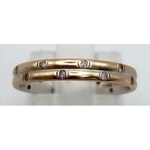 53 - An 18K Yellow and White Gold Diamond Full-Eternity Band Ring. Size L. 2.54g total weight.