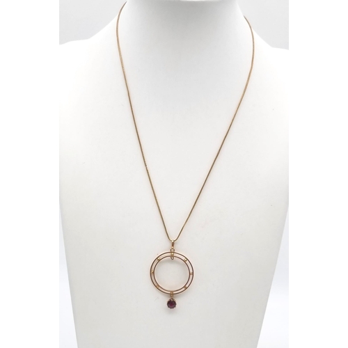 59 - An Antique 9K Rose Gold Garnet Circular Pendant on a 9K Gold Necklace. 25mm diameter. 42cm. 2.79g to... 